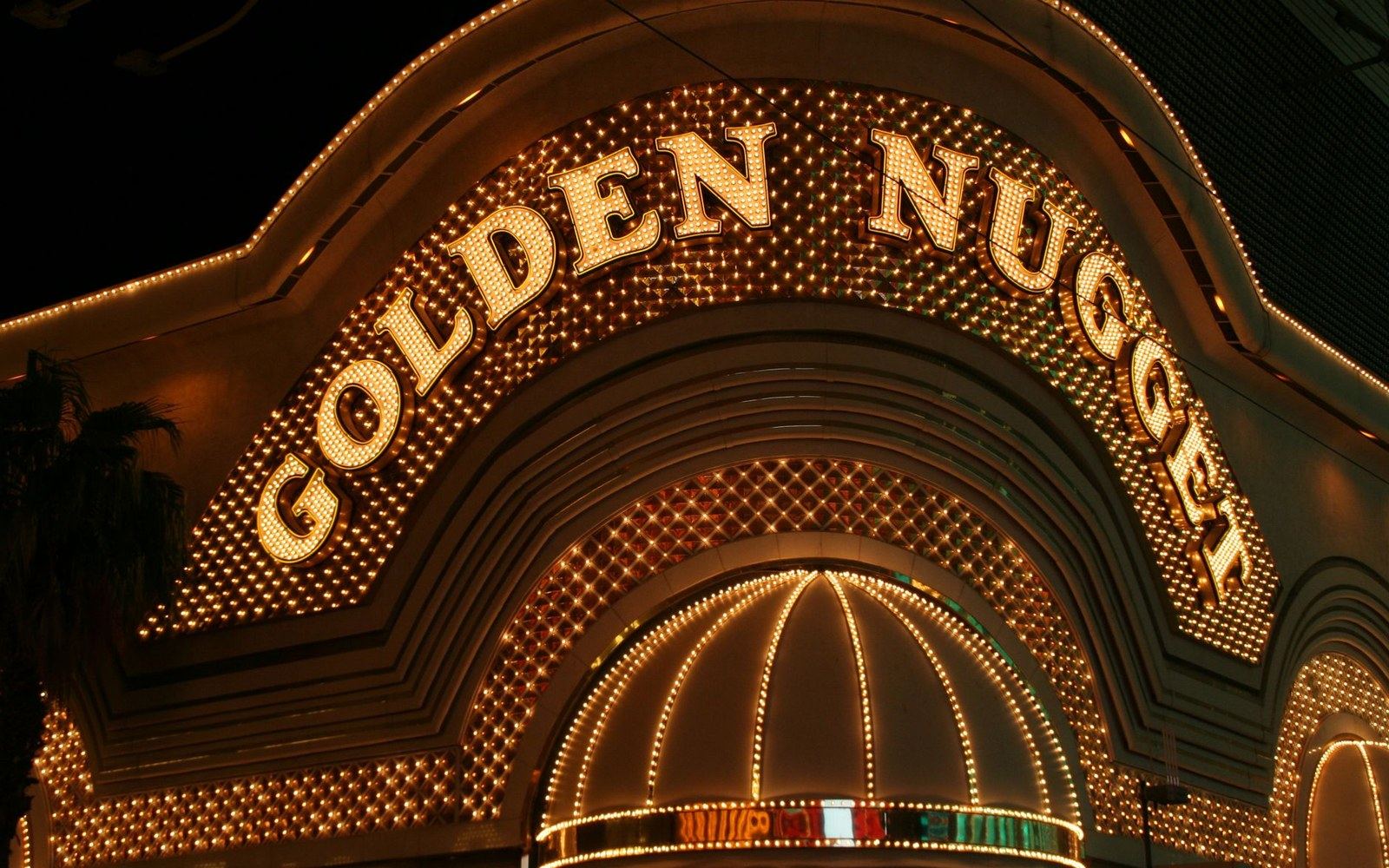 Illuminated Golden Nugget casino sign glowing at night with rows of bulbs